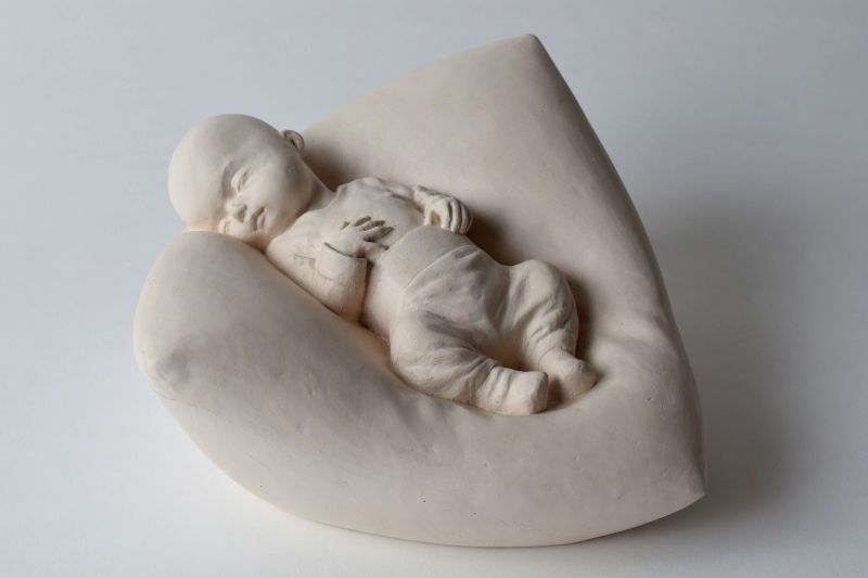 Patrick Niesel – Kind im Kissen